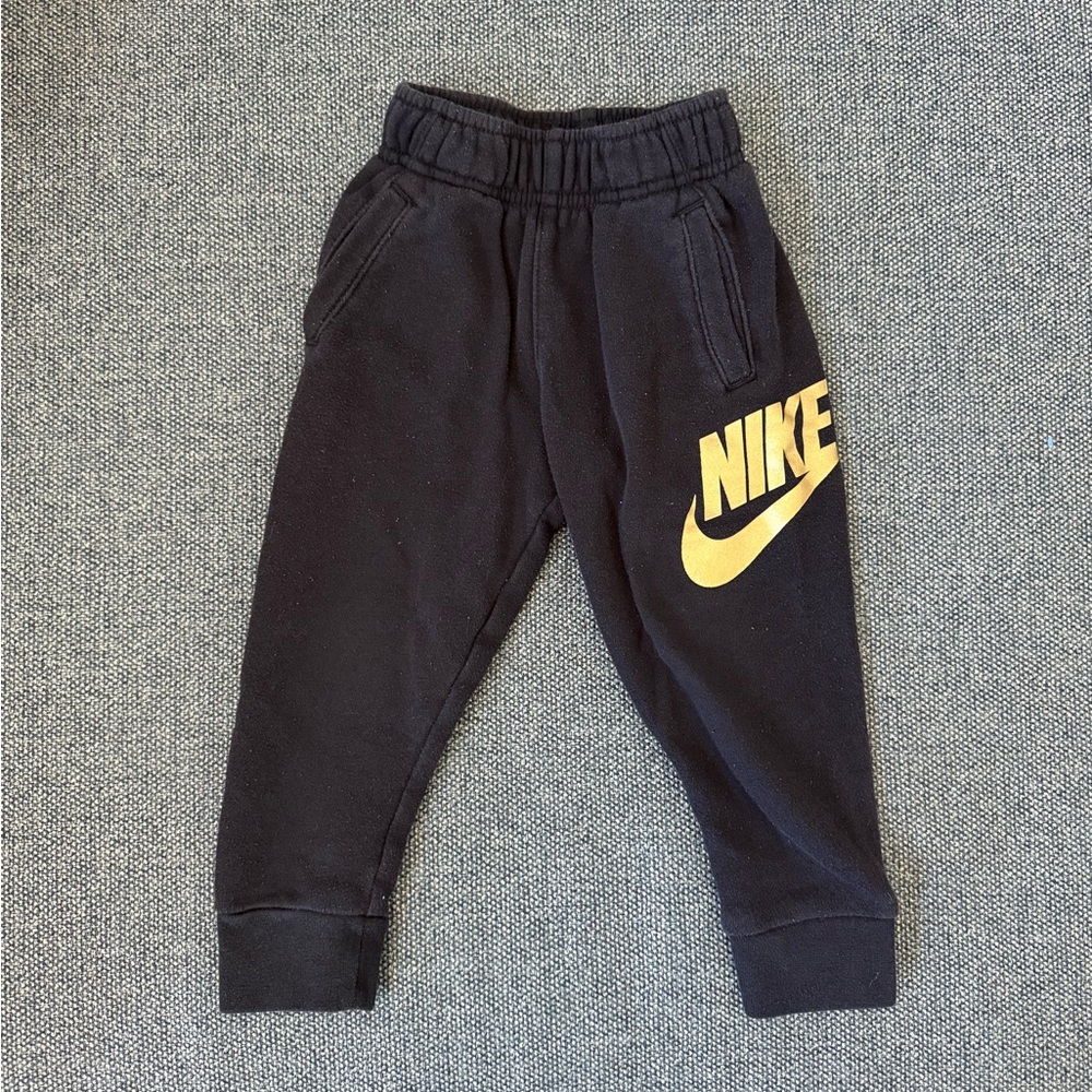 Nike Kids Black Joggers with Gold Logo size 2